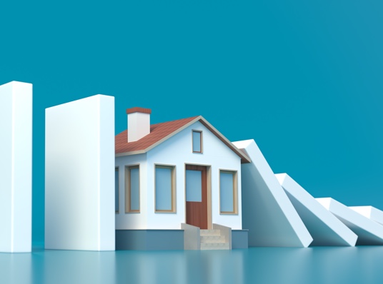 House between falling dominoes, symbolizing homelessness.