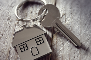 Key with a house-shaped keychain.