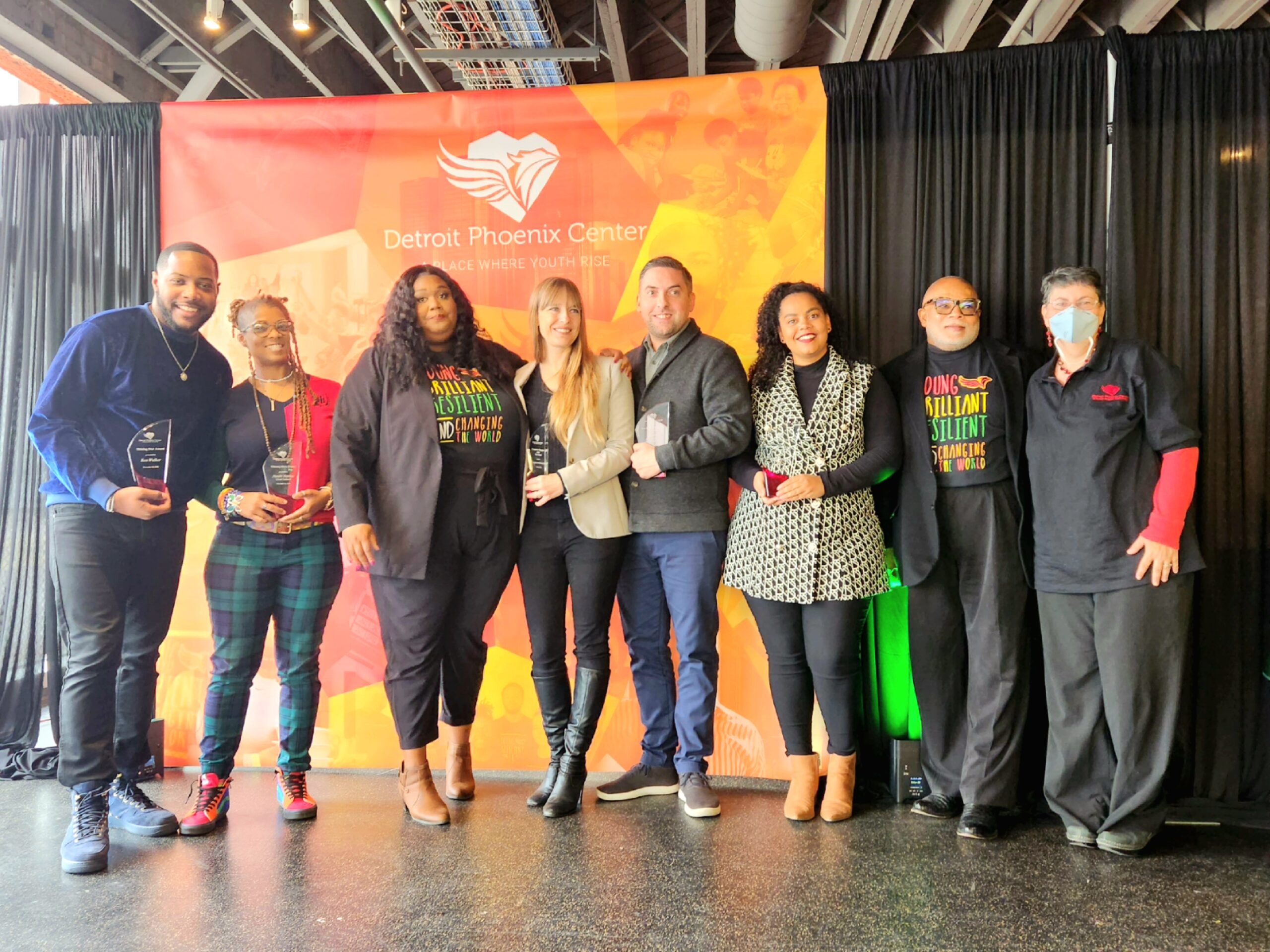 Detroit Phoenix Center Founder and CEO Courtney Smith, third from left, stands beside Jennifer Erb-Downward of U-M’s Poverty Solutions (center), who was named DPC’s 2022 Community Champion of the Year. (Photo by Lauren Slagter)