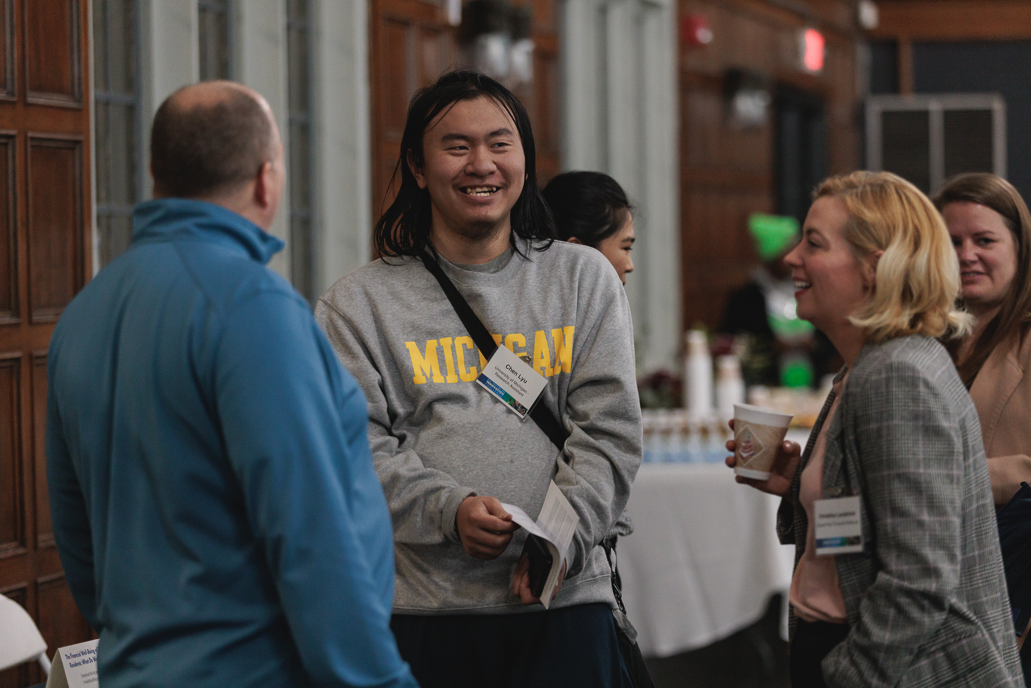 Chen Lyu in conversation with two other attendees.