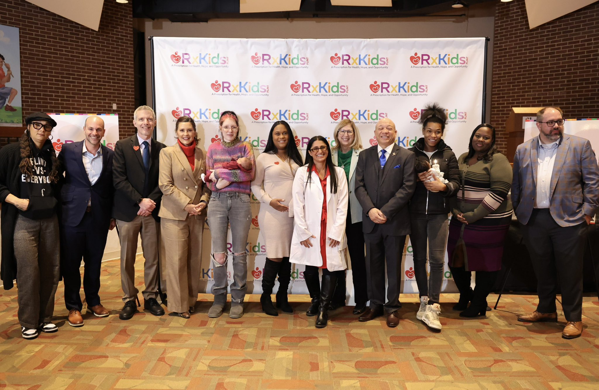 Rx Kids launch press conference. From left to right: Mama Sol, Ridgway White, Luke Shaefer, Governor Gretchen Whitmer, a Flint mom, Alana Turner, Mona Hanna-Attisha, Teresa Woodruff, Sheldon Neeley, a Flint mom, Day Austin, and Jim Ananich.