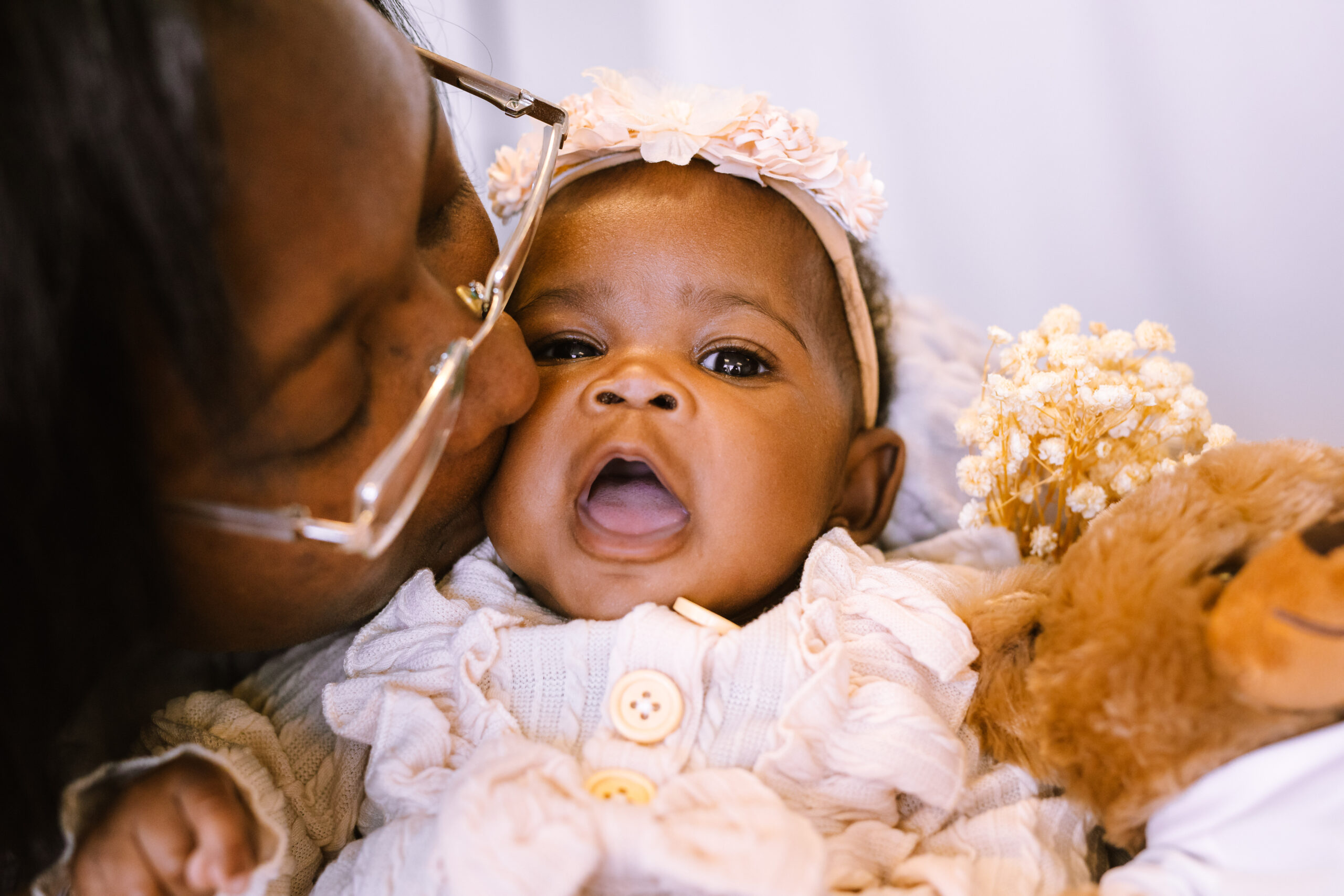 Flint Rx Kids Mother’s Day photo of a mother kissing an infant.