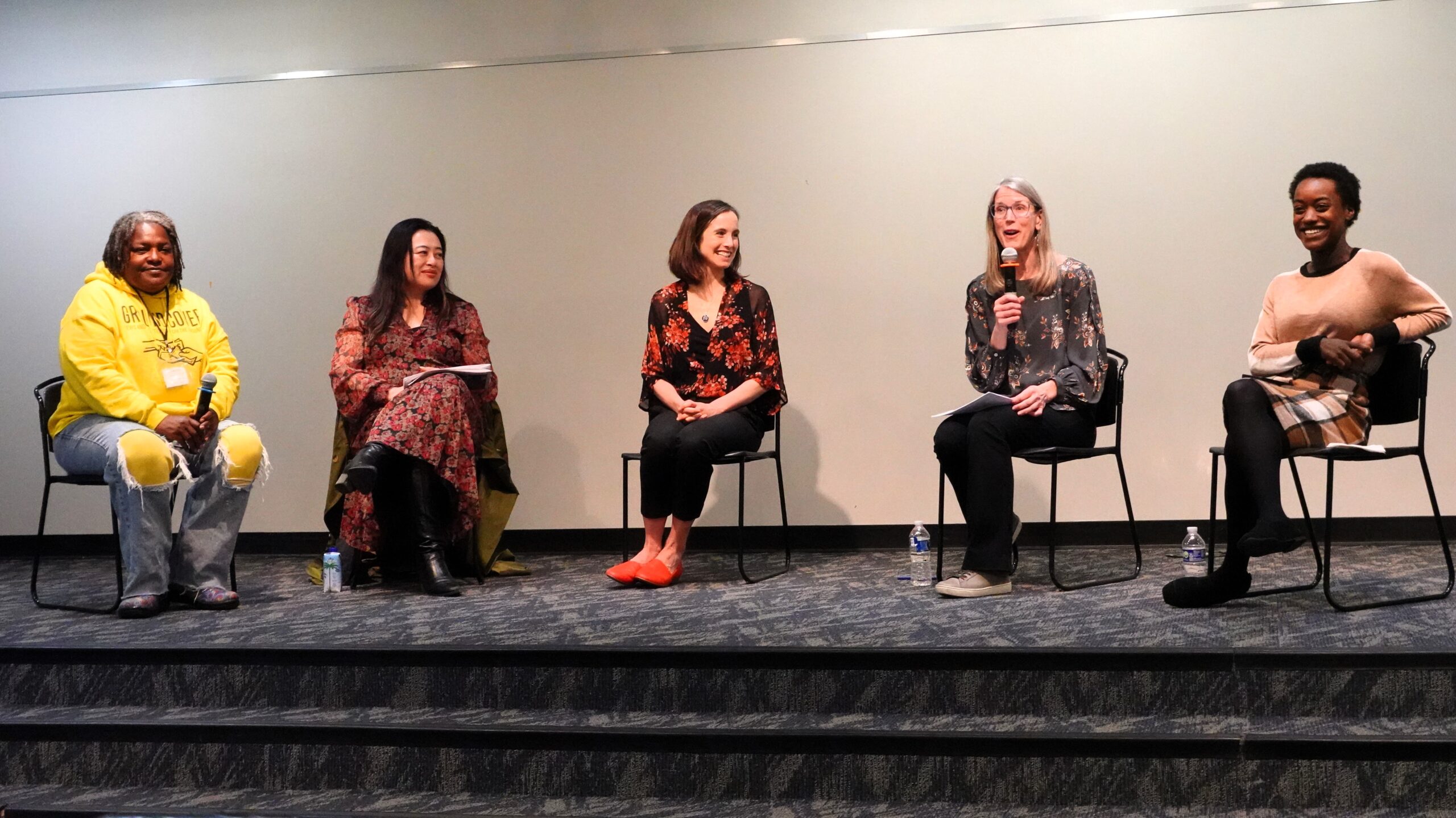 Graphic of Community conversation about Guaranteed Income to Grow Ann Arbor on May 8, 2025, at the downtown Ann Arbor library, Group photo of 5 speakers