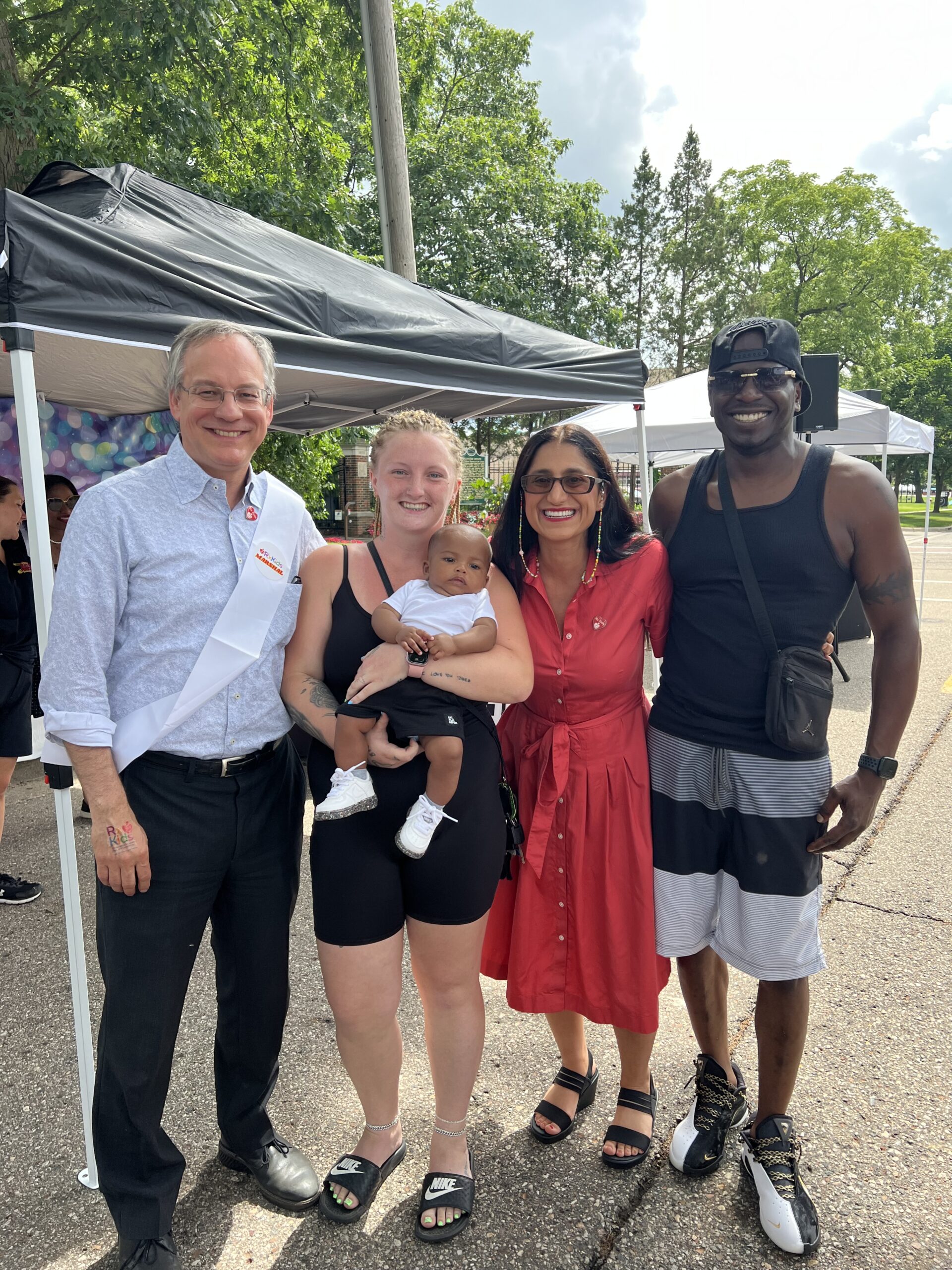 Flint Baby Parade: Group photo with a baby