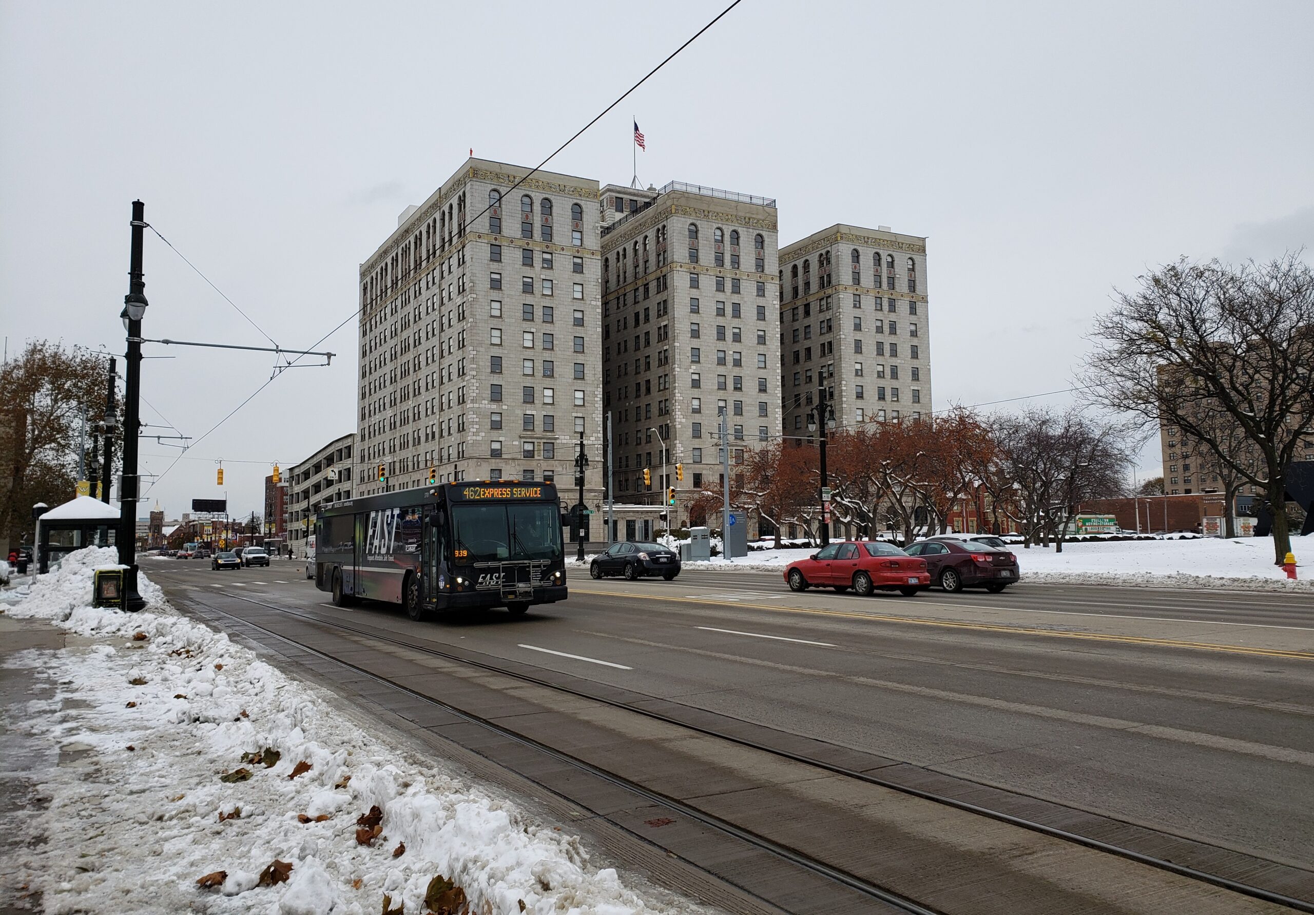 City street in winter with a bus passing by