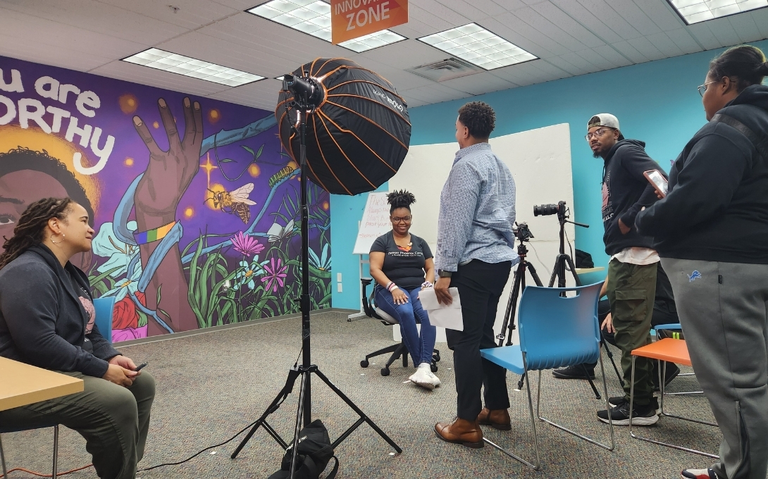 People stand on set to film interviews at the Detroit Phoenix Center