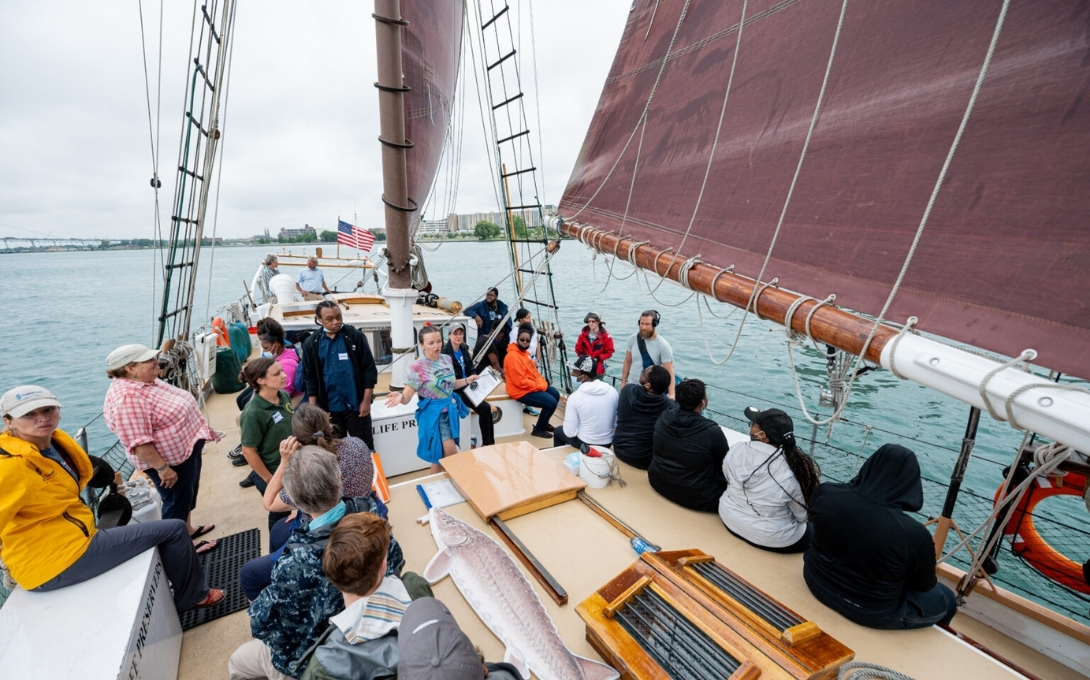 Students ride on a boat on the Detroit River