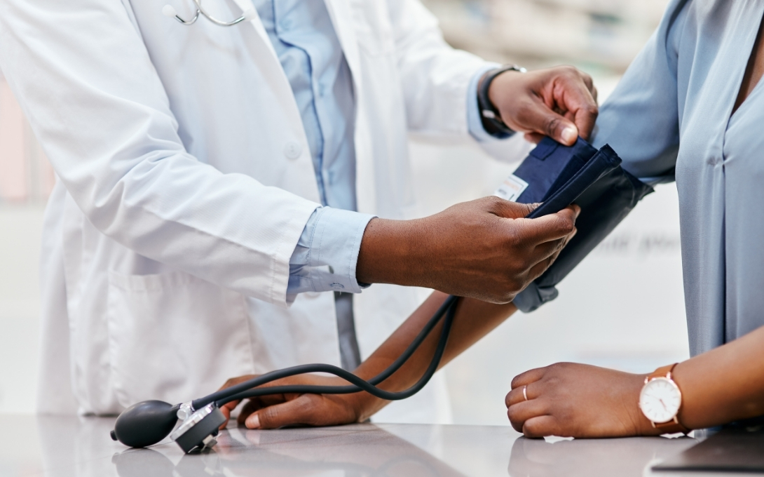 Doctor puts a blood pressure sleeve on a patient